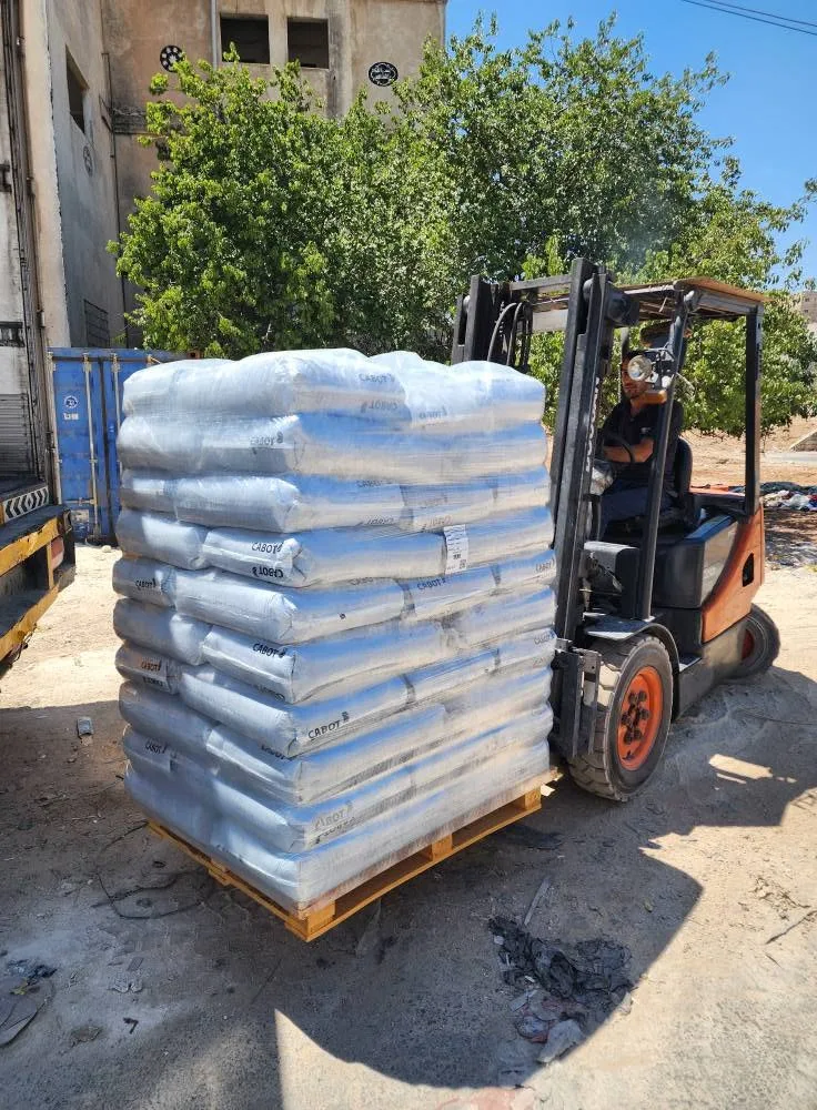 Forklift lifting a wrapped pallet at the factory