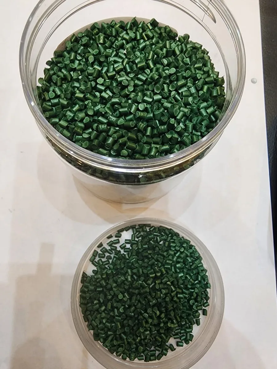 Jars of green masterbatch granules